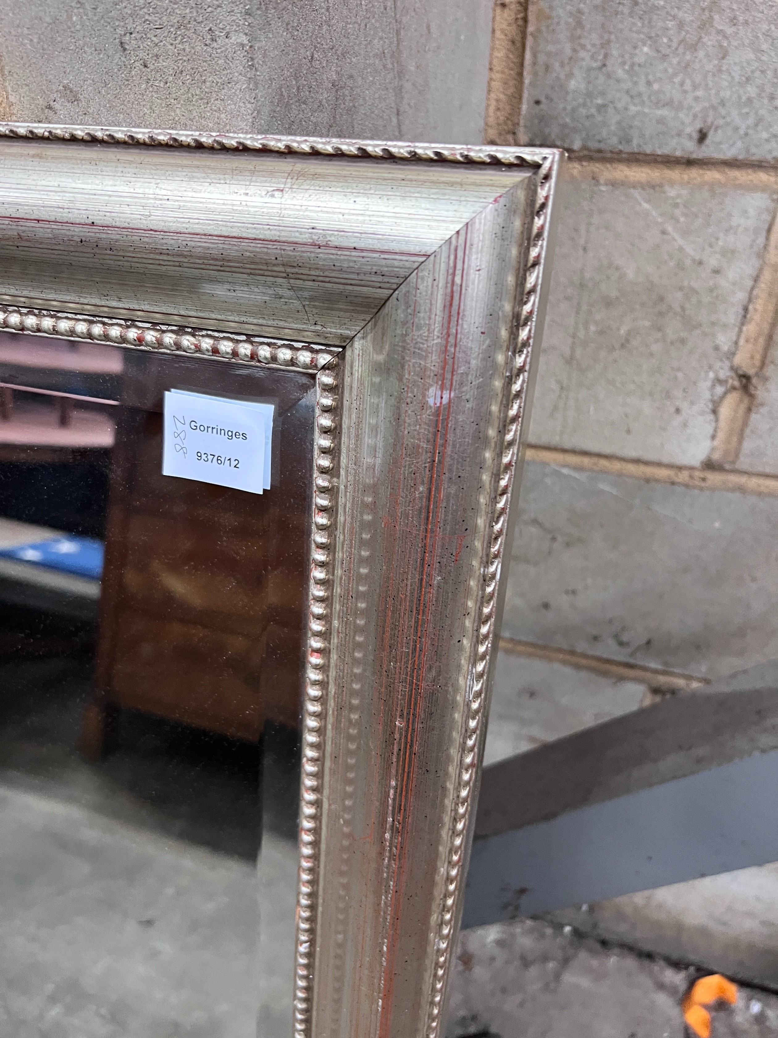 A silvered wood framed wall mirror, width 74cm, height 105cm *Please note the sale commences at 9am.